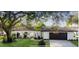 Nice curb appeal, single story home with a large oak tree in the front yard at 570 Casler Ave, Clearwater, FL 33755