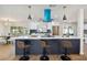 Eat-in kitchen with large island, quartz countertops, and stylish blue vent hood at 570 Casler Ave, Clearwater, FL 33755