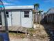 Exterior view of a small storage shed with wooden deck at 1153 Tamarac Dr, Holiday, FL 34690