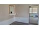 Small dining area with a pass-through to the kitchen and access to a sunroom at 1153 Tamarac Dr, Holiday, FL 34690