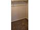 A large walk-in closet with carpeted flooring and hanging rod at 1153 Tamarac Dr, Holiday, FL 34690