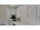 White kitchen with quartz countertops and stainless steel dishwasher at 1153 Tamarac Dr, Holiday, FL 34690