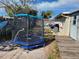 A backyard with a trampoline and a wooden deck at 1153 Tamarac Dr, Holiday, FL 34690