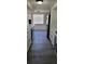 A galley kitchen with white cabinets, and grey vinyl flooring at 1153 Tamarac Dr, Holiday, FL 34690