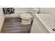 Clean bathroom with white vanity and grey flooring at 1153 Tamarac Dr, Holiday, FL 34690