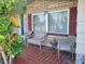 Front porch with tiled flooring and wicker seating at 1153 Tamarac Dr, Holiday, FL 34690