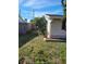 Landscaped side yard with mature shrubbery at 1153 Tamarac Dr, Holiday, FL 34690