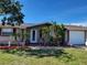 Charming ranch house with a landscaped front yard at 1153 Tamarac Dr, Holiday, FL 34690