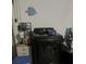 Laundry room with black dryer and storage space at 1153 Tamarac Dr, Holiday, FL 34690