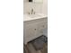 Bathroom with white vanity, quartz countertop, and brushed nickel fixtures at 1153 Tamarac Dr, Holiday, FL 34690