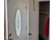 An entryway with a coat closet and decorative door at 1153 Tamarac Dr, Holiday, FL 34690