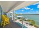 Relaxing balcony with waterfront views and yellow chairs at 295 Bayside Dr, Clearwater Beach, FL 33767