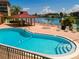 Inviting pool and deck area with gazebo and waterfront view at 105 Island Way # 121, Clearwater Beach, FL 33767