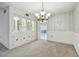 Elegant dining room with a chandelier and built-in cabinetry at 1001 Eden Isle Ne Dr # 1, St Petersburg, FL 33704