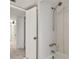 Simple bathroom with white tile and a shower/tub combo at 1001 Eden Isle Ne Dr # 1, St Petersburg, FL 33704