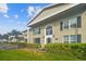 Building entrance with landscaping and brick facade at 1001 Eden Isle Ne Dr # 1, St Petersburg, FL 33704