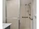 Walk-in shower with grab bars and tiled walls at 1001 Eden Isle Ne Dr # 1, St Petersburg, FL 33704