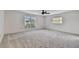 Spacious bedroom with carpeted floor and large window at 1001 Eden Isle Ne Dr # 1, St Petersburg, FL 33704
