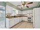 Bright kitchen with white cabinets, granite countertops, and double oven at 1001 Eden Isle Ne Dr # 1, St Petersburg, FL 33704