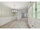 Dining area with built-in hutch and a chandelier at 1001 Eden Isle Ne Dr # 1, St Petersburg, FL 33704