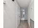 Bright hallway with carpeted floor, leading to bathroom and other rooms at 1001 Eden Isle Ne Dr # 1, St Petersburg, FL 33704