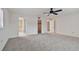 Large bedroom with carpet, ceiling fan, and access to bathroom and closet at 1001 Eden Isle Ne Dr # 1, St Petersburg, FL 33704