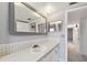 Bathroom with vanity, large mirror, and updated fixtures at 1001 Eden Isle Ne Dr # 1, St Petersburg, FL 33704