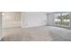 Spacious living room with large windows and neutral decor at 1001 Eden Isle Ne Dr # 1, St Petersburg, FL 33704