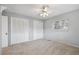 Bedroom with neutral walls, carpet, and double closets at 1001 Eden Isle Ne Dr # 1, St Petersburg, FL 33704