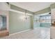 Bright dining area with view into the kitchen and sunroom at 1001 Eden Isle Ne Dr # 1, St Petersburg, FL 33704