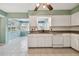 Kitchen with white cabinets, granite countertops, and a dishwasher at 1001 Eden Isle Ne Dr # 1, St Petersburg, FL 33704