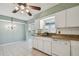 Kitchen with granite countertops and white cabinets at 1001 Eden Isle Ne Dr # 1, St Petersburg, FL 33704