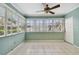 Sunroom with tiled floor and multiple windows at 1001 Eden Isle Ne Dr # 1, St Petersburg, FL 33704