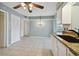 Simple dining area with chandelier and access to kitchen at 1001 Eden Isle Ne Dr # 1, St Petersburg, FL 33704