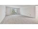 Open living area with carpeted floors and a view of the outside at 1001 Eden Isle Ne Dr # 1, St Petersburg, FL 33704