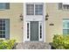 Building's entrance with dark green door and brick exterior at 1001 Eden Isle Ne Dr # 1, St Petersburg, FL 33704