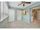 Bright sunroom with tile floors, built-in storage, and access to the outdoors at 1001 Eden Isle Ne Dr # 1, St Petersburg, FL 33704