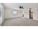 Bright bedroom featuring carpet, large window, and access to bathroom and closet at 1001 Eden Isle Ne Dr # 1, St Petersburg, FL 33704