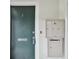 Building entry with a teal door, mailbox, and nearby mail slot at 1001 Eden Isle Ne Dr # 1, St Petersburg, FL 33704