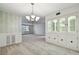 Bright dining room featuring a built-in hutch and chandelier at 1001 Eden Isle Ne Dr # 1, St Petersburg, FL 33704