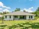 Charming single-story house with a covered patio and well-manicured lawn at 6436 Summit View Dr, Brooksville, FL 34601