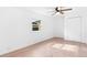 Bright bedroom with light wood floors and ceiling fan at 13344 Sorrento Dr, Largo, FL 33774