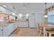 Well-equipped kitchen with white cabinetry and breakfast nook at 1200 Country Club Dr # 5402, Largo, FL 33771