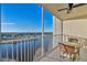 Spacious balcony with lake and golf course views, table and chairs at 1200 Country Club Dr # 5402, Largo, FL 33771