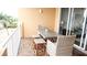 Balcony with a table and chairs for outdoor dining at 692 Bayway Blvd # 202, Clearwater Beach, FL 33767