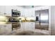 Bright kitchen with stainless steel refrigerator and granite counters at 692 Bayway Blvd # 202, Clearwater Beach, FL 33767