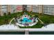 Aerial view of condo building, pool, and waterfront at 5130 Brittany S Dr # 408, St Petersburg, FL 33715