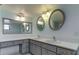 Double vanity bathroom with updated fixtures and mirrors at 5130 Brittany S Dr # 408, St Petersburg, FL 33715