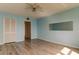 Bedroom with hardwood floors and mirrored wall at 5130 Brittany S Dr # 408, St Petersburg, FL 33715