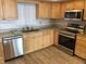 Bright kitchen with wood cabinets, granite counters, and stainless steel appliances at 5130 Brittany S Dr # 408, St Petersburg, FL 33715